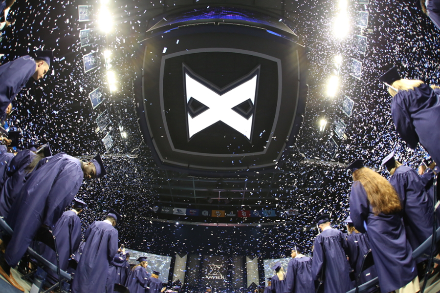 Confetti falls as graduates from the Class of 2022 celebrate at Xavier University's 184th Commencement on Saturday, May 14, 2022, at the Cintas Center