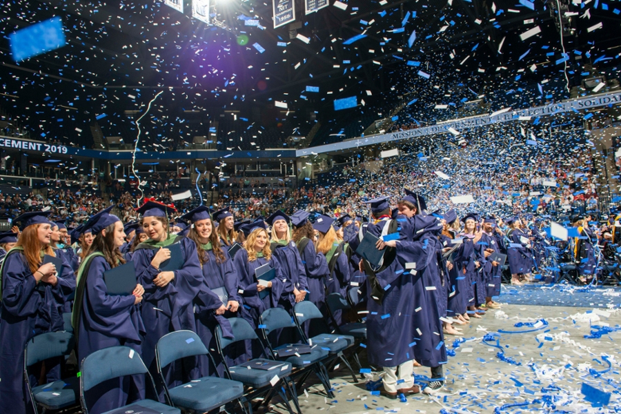 Confetti falls as graduates celebrate at Xavier University's 183rd Commencement at Cintas Center Arena.