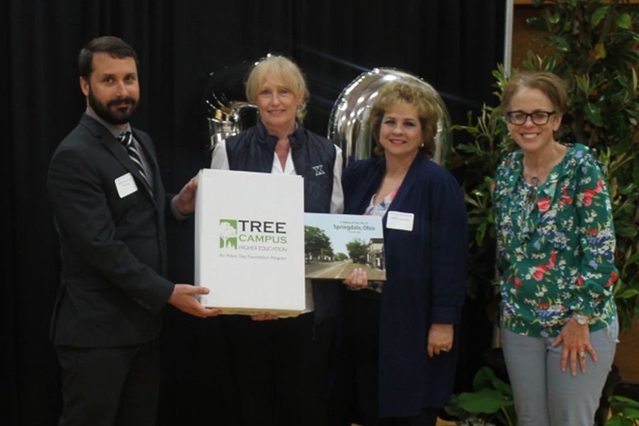 Horticultural Specialist Karen McCabe, School of Education Director Kathy Winterman and Senior Teaching Professor Julie Kugler-Ackley receive a plaque from the Arbor Day Foundation. 
