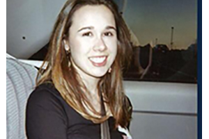 Emily Barbero smiles while sitting in the passenger seat of a car