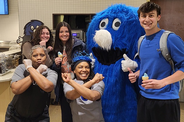 Students and cafeteria workers post with the Blue Blob mascot and their blue ice cream cones