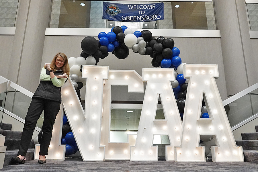 Picture of President Hanycz next to NCAA sign