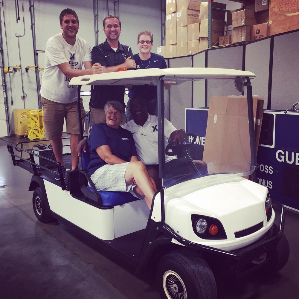 Connor Barnes with his athletic training colleagues in a golf cart