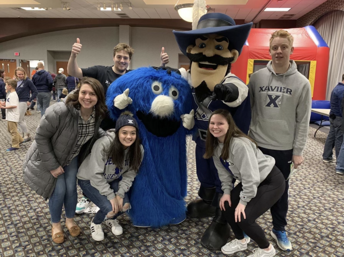 Members of the Xavier Mascot Team pose with Xavier mascots.