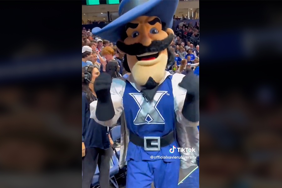 Screenshot of a Xavier TikTok video. The D'Artagnan mascot is giving two thumbs up inside the Cintas Center arena during a basketball game