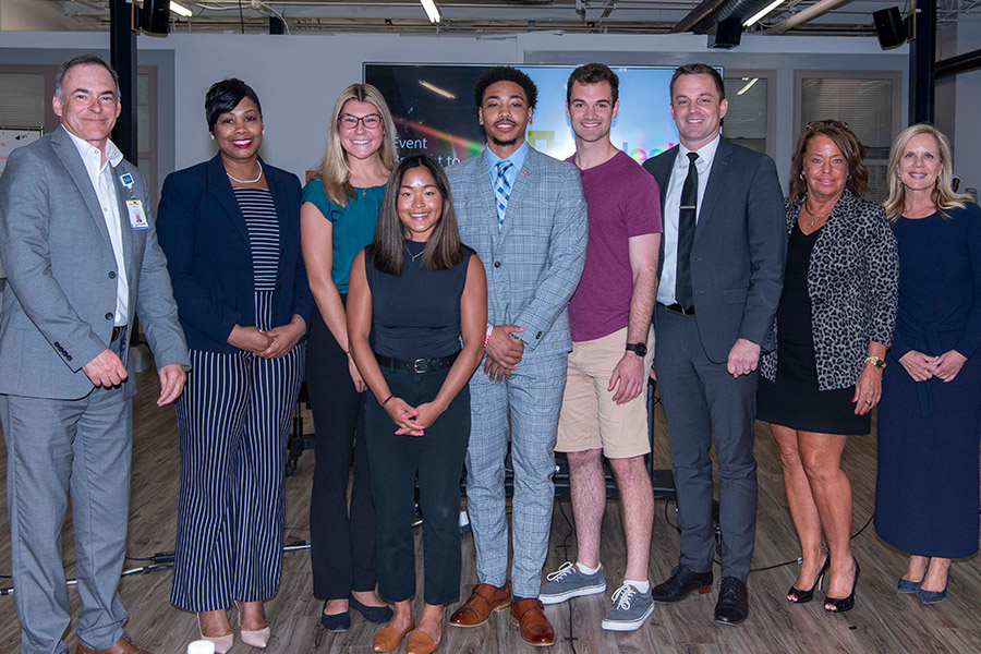 Xavier students stand alongside senior-level TriHealth employees inside Xavier's Center for Innovation.
