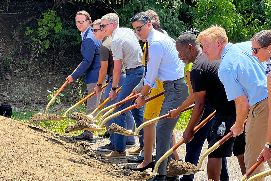 Cincinnati Mayor Aftab Pureval and several community leaders lift dirt with ceremonial shovels near Xavier University's campus. 