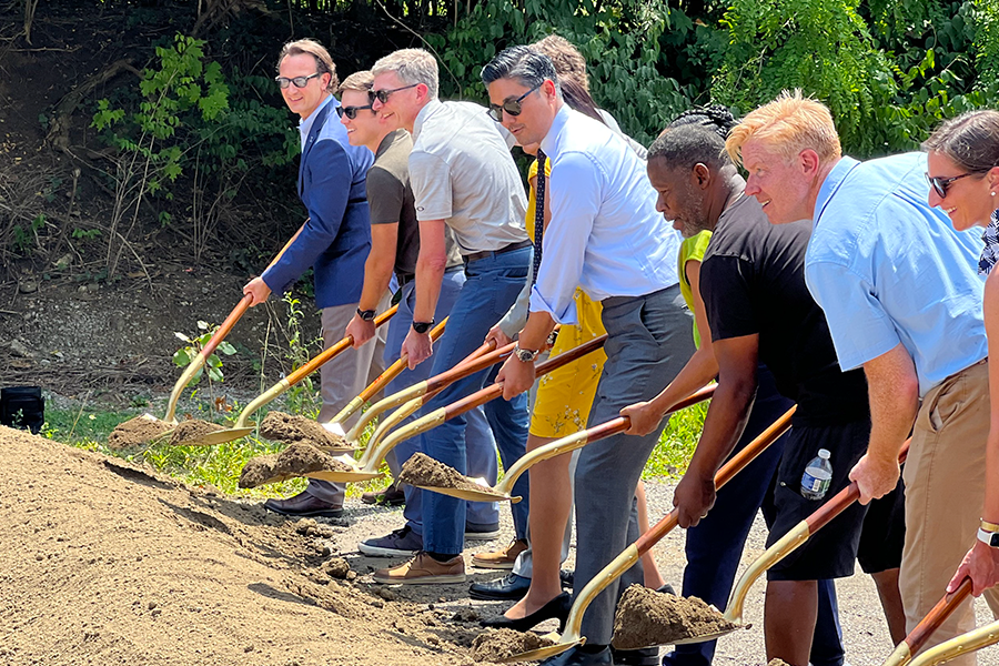 Cincinnati Mayor Aftab Pureval and several community leaders lift dirt with ceremonial shovels near Xavier University's campus.