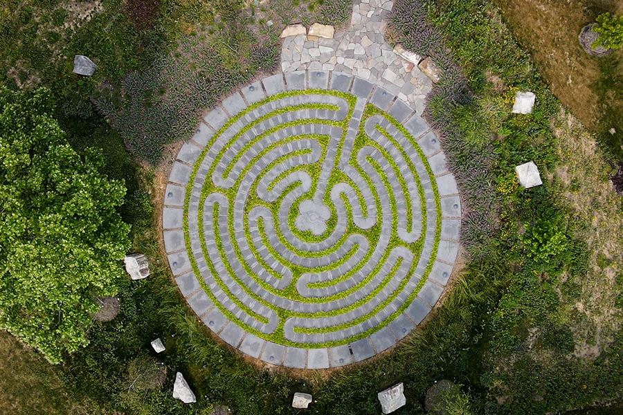 An overhead view of a seven-ring labyrinth surrounded by green space on Xavier University's campus.