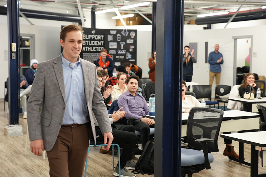 Xavier student Jake Reisig is beaming as he walks up to receive his first-place award for the Xavier Pitch Competition.