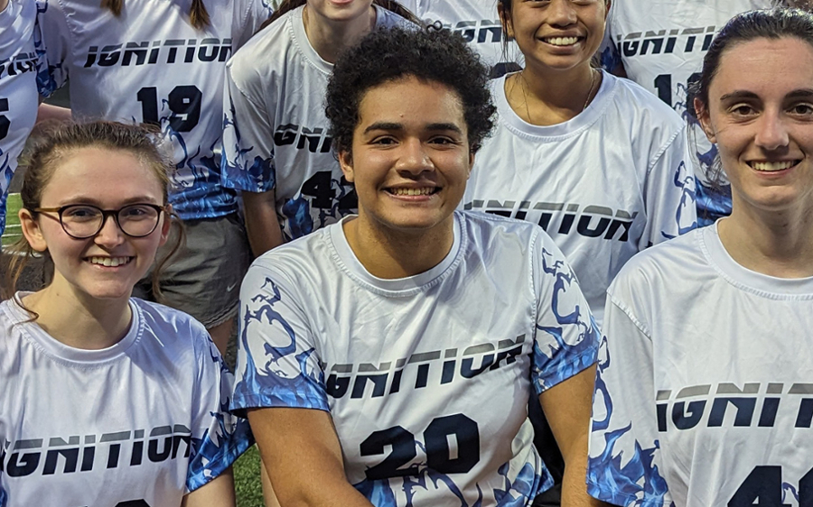 Sydney Bowie sits at the center in a picture of the Women's Ultimate Frisbee Team