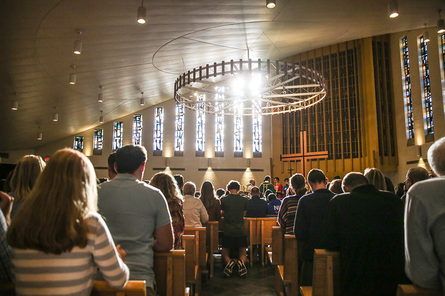 The inside of Bellarmine Chapel with the pews full of students.