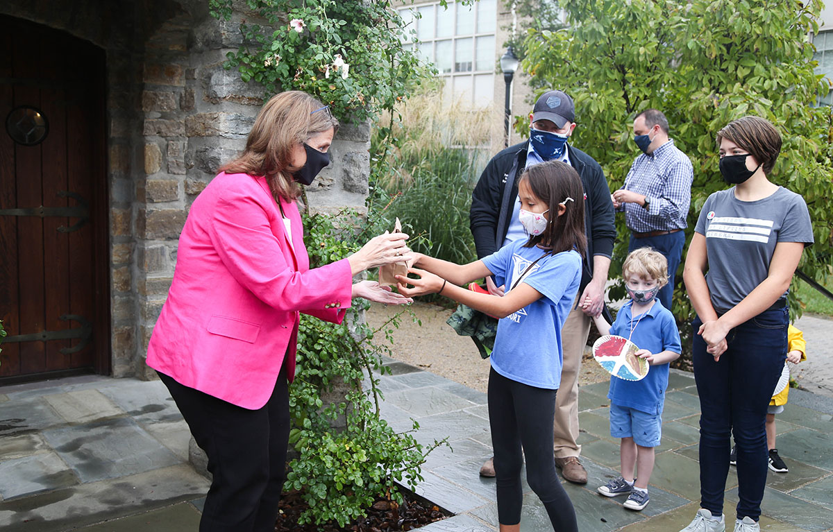 President Hanycz receives a craft as a present from a Montessori Lab School student.