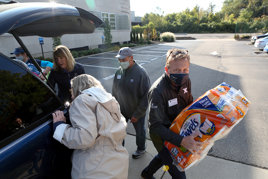 Photo of XU Students and Faculty taking Products out of the Trunk of a Car