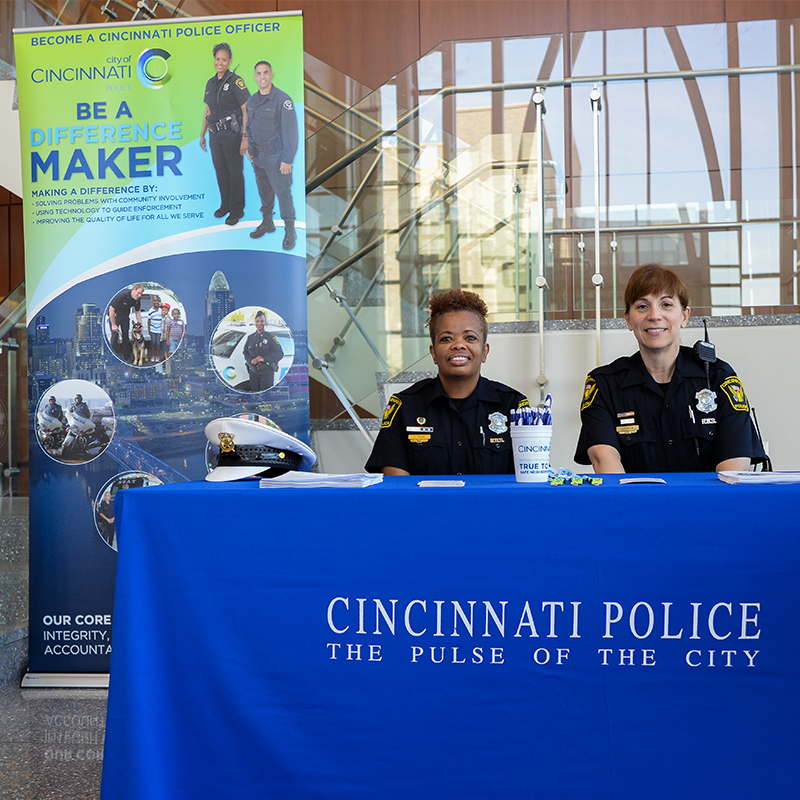 Police officers setting up a booth at a Xavier Career fair 