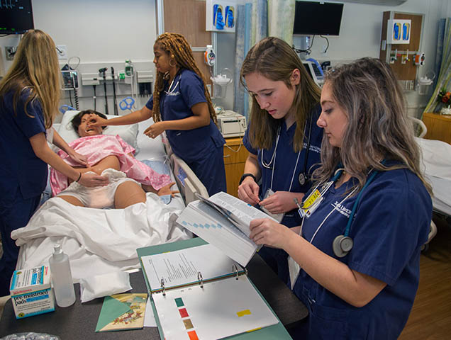 Nursing students learning patient care in a simulation lab