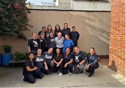 Xavier OTD (gray shirts with Xavier logo) and Rafael Landivar OT/PT (some in gray, some in blue, without Xavier logo) students working with children at CREAR.