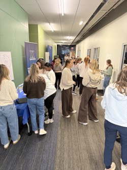 students gather in hallway to engage in booths at advocacy power hour