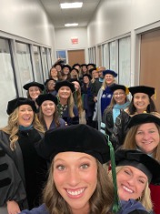 selfie angle photo of students waiting to go out to commencement stage