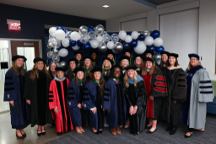 OTD faculty and class of 2026 pose for photo after graduation ceremony