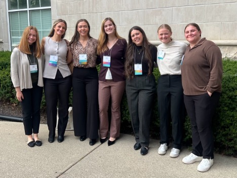 students pose for photo after poster presentations