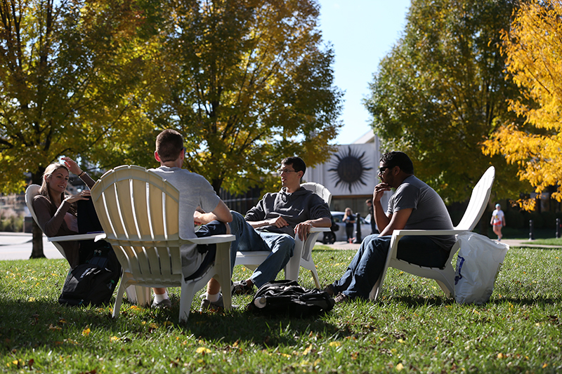 Photo of Students sitting outside on the Xavier Yard