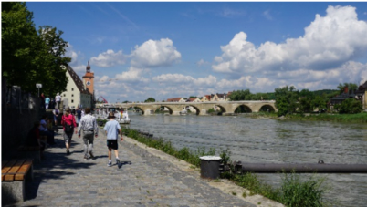 People walking alongside a river in Bavaria, Germany