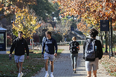 Photo of Students walking through the Academic Mall