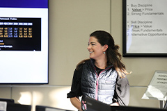 Photo of a Professor in front of a Projector Screen