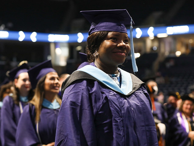 Student in their cap and gown during their graduation ceremony