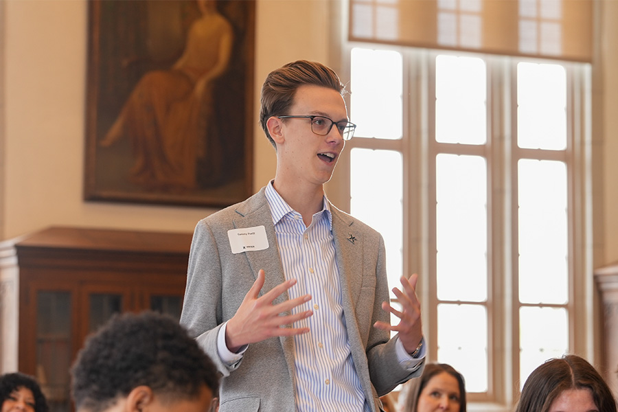 Individual who is participating in the event speaks up to add to the conversation