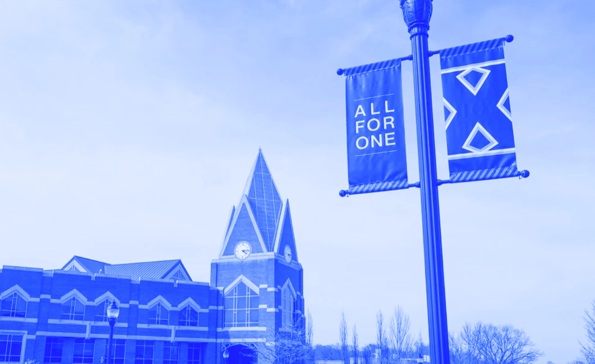 streetpost sign above Xavier's campus saying all for one