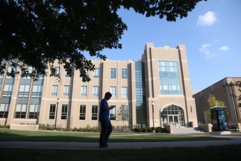 Student standing in front of Alter Hall.