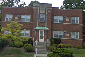 Photo of the exterior of the 1019 Dana Ave. apartment building. There are two stories. The building is red brick.