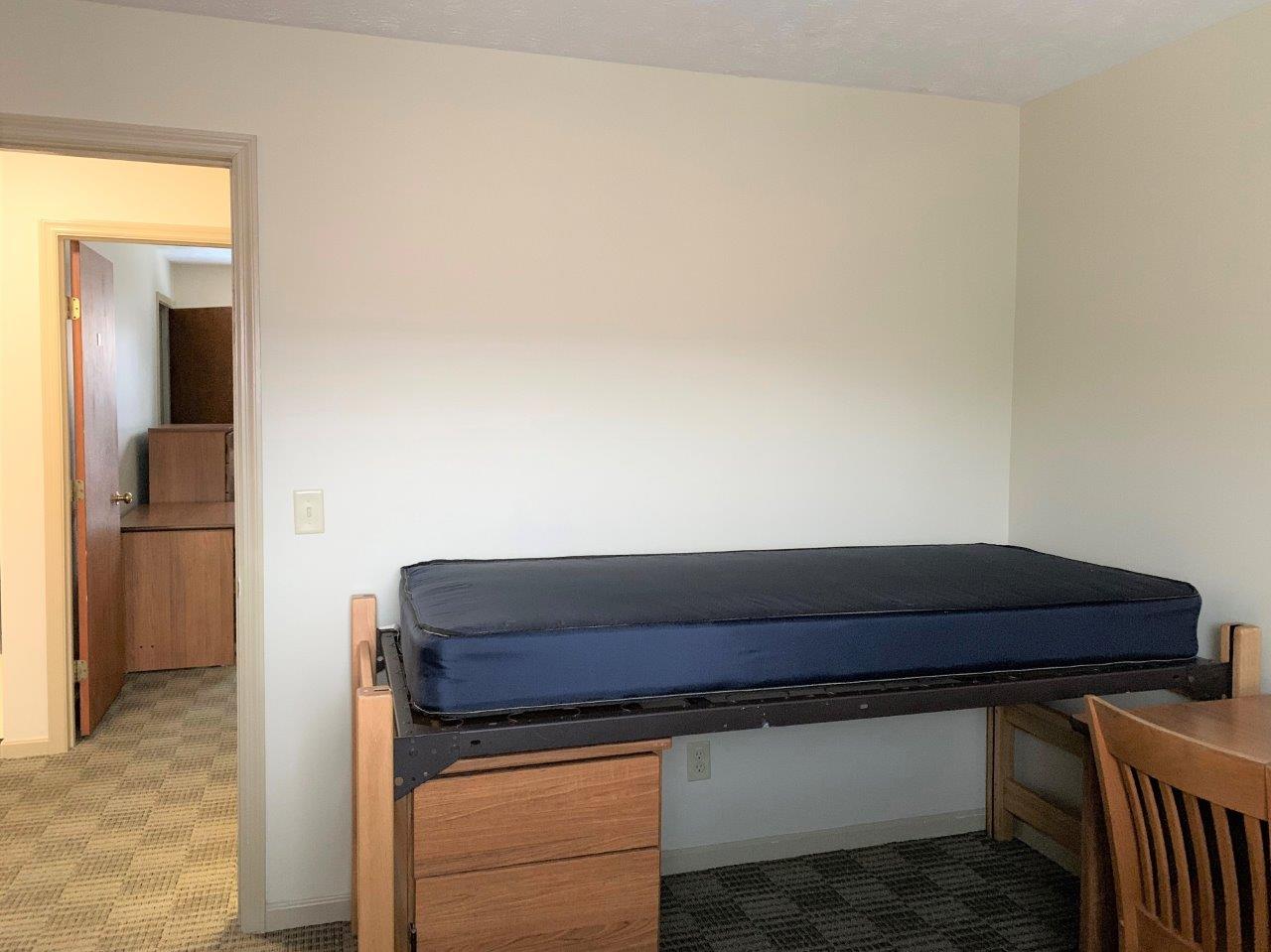 Village Apartments Double Bedroom showing a bed next to a desk