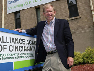 Graduate of the masters in school counseling program standing in front of a business