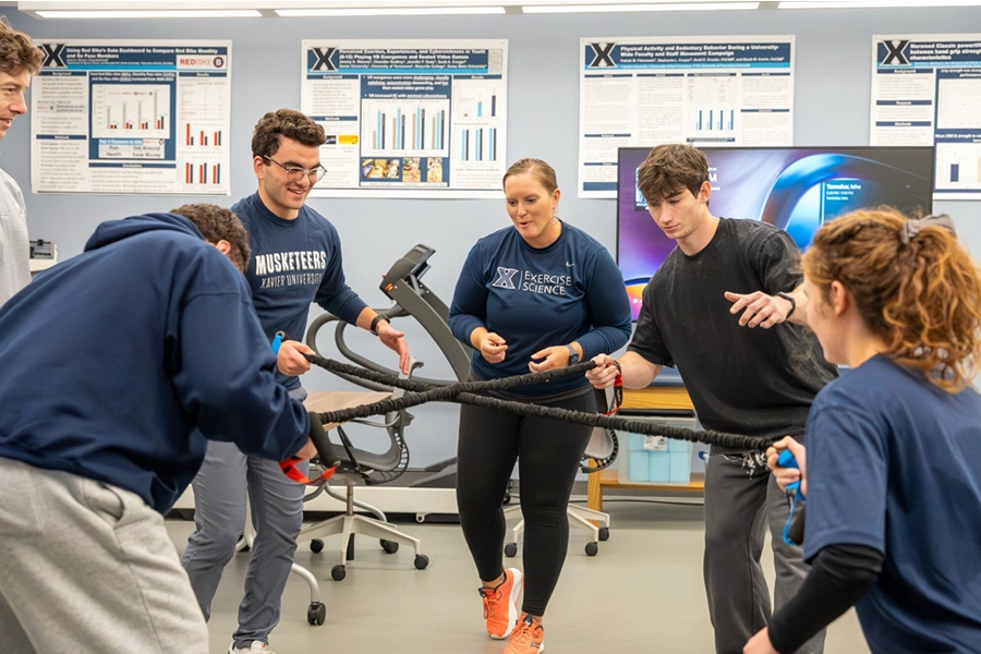 students form a circle and pull on ropes with the person standing across from them