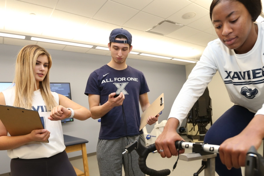 three students use health monitoring equipment on the treadmill