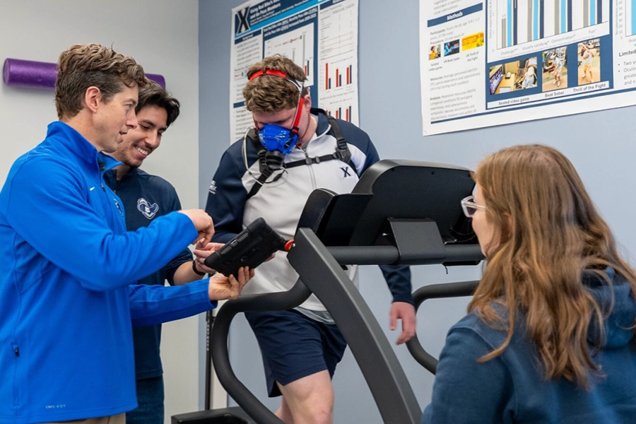 A student wears a mask while walking on a treadmill