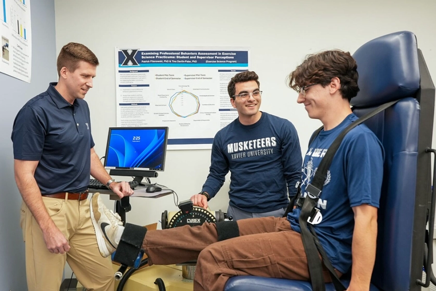 Two students and a professor testing out health monitering equipment