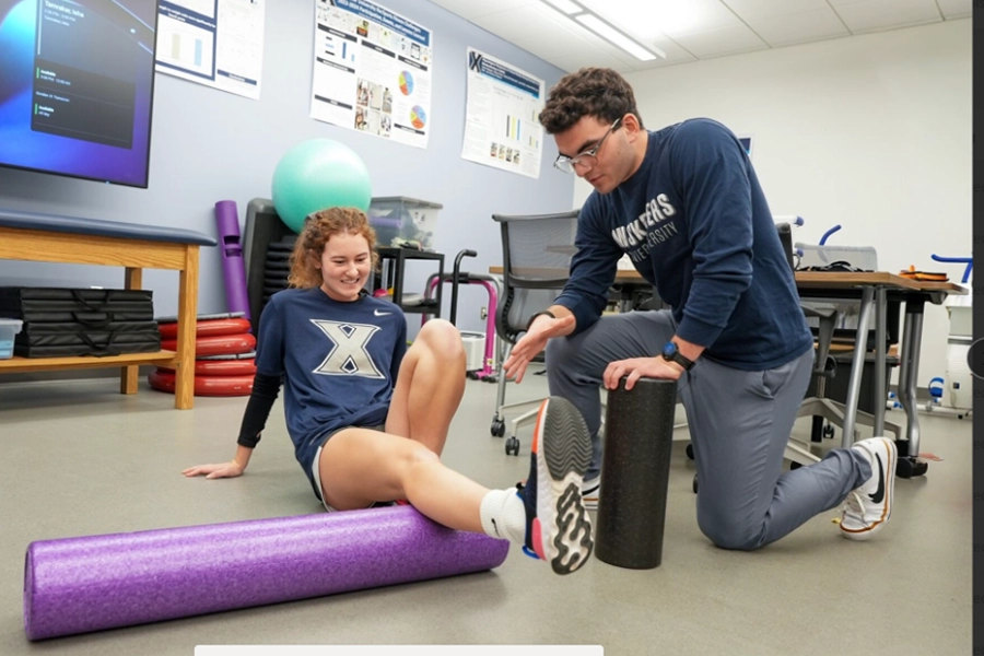 Two students stretching on the floor