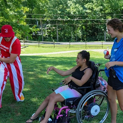 Ellie Schulz laughing at a clown with a person in a wheelchair