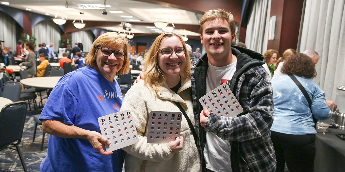 A Xavier student with their family playing bingo