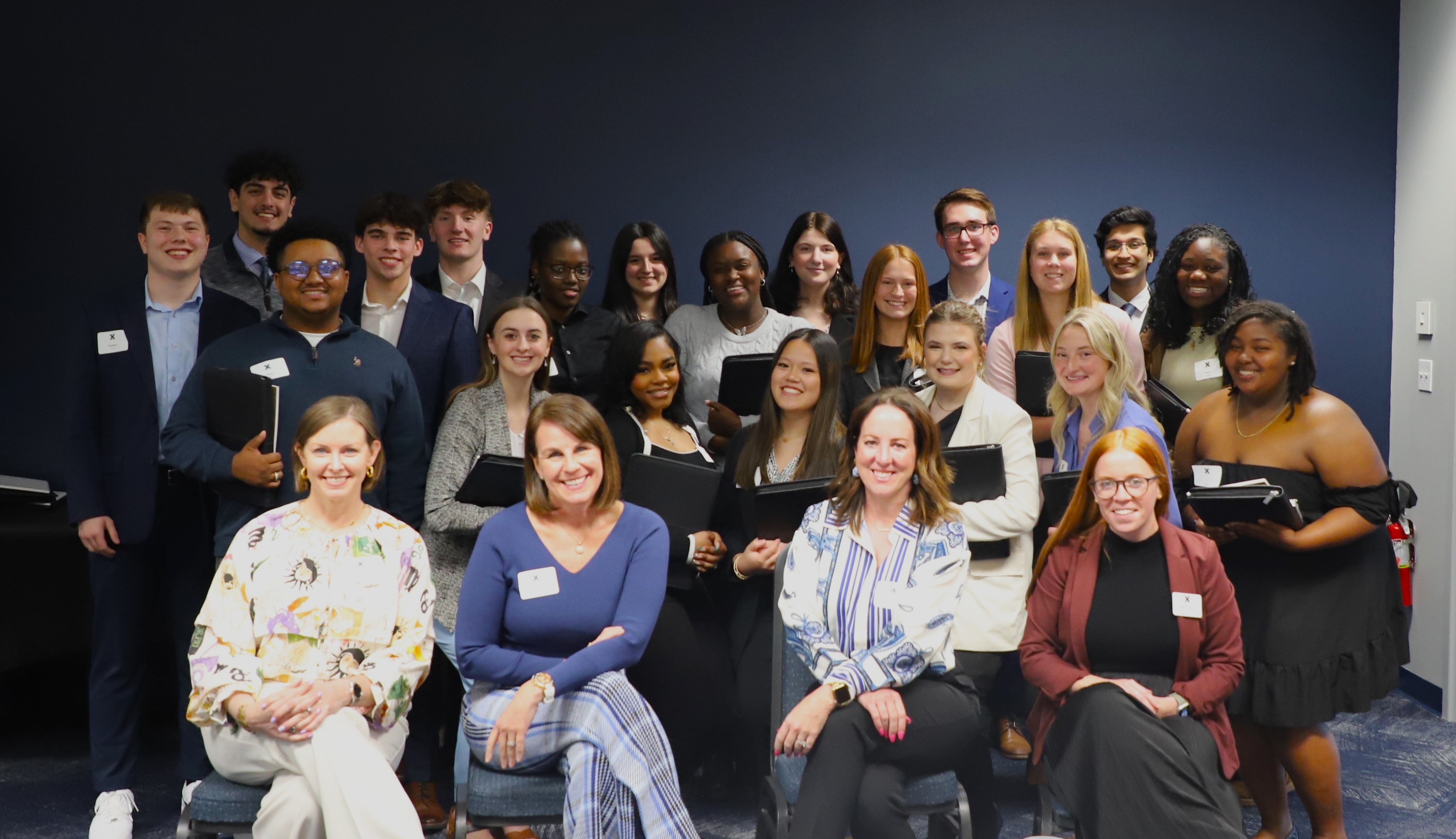 group of students in business attire smiling