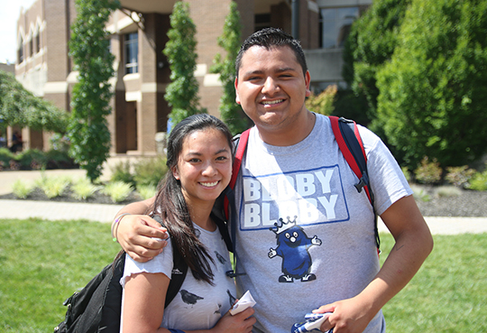 Two Xavier students smiling outside of Gallagher Student Center on campus