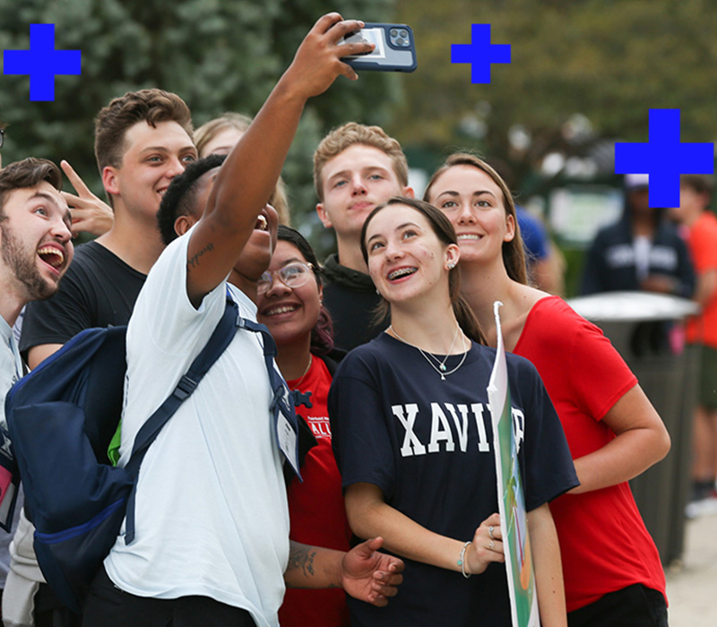 A group of Xavier students pause for a group selfie during orientation week
