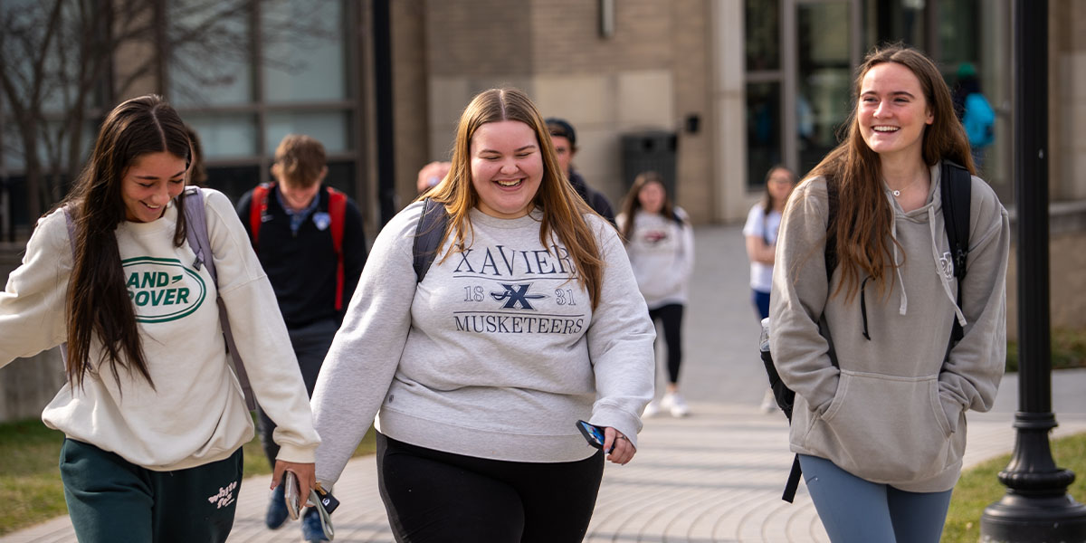 A group of Xavier students walking on campus