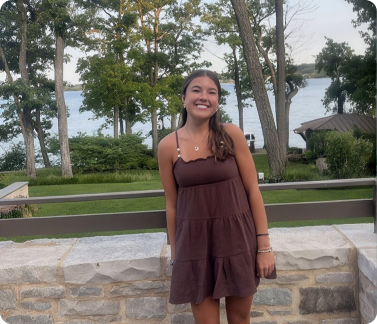 Lauren standing outdoors near a lake