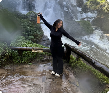 Nylah standing in front of a waterfall