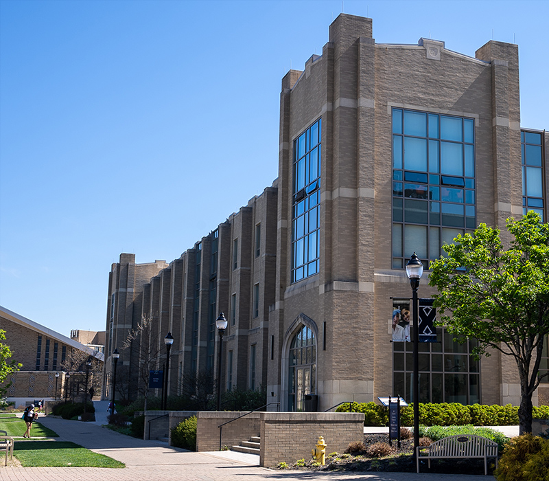 Exterior of Alter Hall in front of a cloudless blue sky.